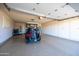 Spacious garage with epoxy floor, built-in cabinets, and room for a golf cart at 19217 N Concho Cir, Sun City, AZ 85373