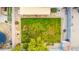 Aerial view of backyard featuring grass, a covered patio, trees, and low-maintenance desert landscaping at 1942 E Connemara Dr, San Tan Valley, AZ 85140