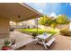 Outdoor patio with a picnic table overlooking the grassy backyard, perfect for relaxing and entertaining at 1942 E Connemara Dr, San Tan Valley, AZ 85140