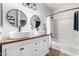 This bright bathroom features double sinks, modern lighting, and a shower-tub combo with modern fixtures at 1942 E Connemara Dr, San Tan Valley, AZ 85140