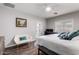 This inviting bedroom is complete with a ceiling fan, hardwood floors, and lots of natural light at 1942 E Connemara Dr, San Tan Valley, AZ 85140