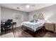 This serene bedroom is complete with a ceiling fan, hardwood floors, and lots of natural light at 1942 E Connemara Dr, San Tan Valley, AZ 85140