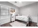 Bright bedroom with a white bed frame, wood floors, and decorative ukuleles on the wall at 1942 E Connemara Dr, San Tan Valley, AZ 85140