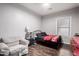 Cozy bedroom with wood floors, a comfortable chair, and a stylish black metal bed frame at 1942 E Connemara Dr, San Tan Valley, AZ 85140