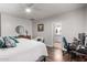 This warm bedroom features with a ceiling fan, hardwood floors, and view of the ensuite bathroom at 1942 E Connemara Dr, San Tan Valley, AZ 85140