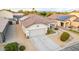 Aerial view of a home with a tile roof, solar panels, desert landscaping, and a paved driveway at 1942 E Connemara Dr, San Tan Valley, AZ 85140