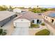 Aerial view of a home with a tile roof, solar panels, desert landscaping, and a two-car garage at 1942 E Connemara Dr, San Tan Valley, AZ 85140