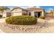 Desert landscape with a rock border surrounds the front yard at 1942 E Connemara Dr, San Tan Valley, AZ 85140