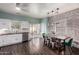 Bright eat-in kitchen features stainless appliances, white subway tiles, and brick accent wall with natural light at 1942 E Connemara Dr, San Tan Valley, AZ 85140