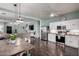 Open concept kitchen with stainless steel appliances, wooden table with seating and view to the living area at 1942 E Connemara Dr, San Tan Valley, AZ 85140