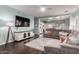Open-concept living room with a comfortable sofa, entertainment center, and view into the kitchen at 1942 E Connemara Dr, San Tan Valley, AZ 85140