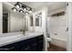 Beautiful bathroom with modern vanity, upgraded lighting and fixtures, and shower-tub combination at 2228 N 52Nd St # 245, Phoenix, AZ 85008