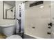 This bathroom features a shower-tub combo with a glass door and sleek white tile at 2228 N 52Nd St # 245, Phoenix, AZ 85008