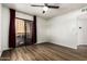 Well-lit bedroom with wood flooring, ceiling fan, and sliding glass door to private patio at 2228 N 52Nd St # 245, Phoenix, AZ 85008