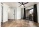 This bedroom features a ceiling fan, access to the patio, and neutral-colored tiling at 2228 N 52Nd St # 245, Phoenix, AZ 85008