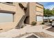 Multi-story condo building with tan stucco exterior, staircase, and covered parking, offering convenient access at 2228 N 52Nd St # 245, Phoenix, AZ 85008