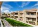 Well-maintained apartment complex featuring multiple floors, landscaping, and a green lawn at 2228 N 52Nd St # 245, Phoenix, AZ 85008
