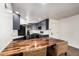 Open kitchen features modern appliances, stylish gray cabinetry, wood butcher block bar and backsplash at 2228 N 52Nd St # 245, Phoenix, AZ 85008