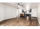 Open living space with wood floors, ceiling fan, and kitchen featuring dark cabinets and stainless steel appliances at 2228 N 52Nd St # 245, Phoenix, AZ 85008