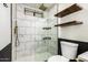 This walk-in shower features a glass partition with sleek, modern fixtures and marble-like tiles at 2228 N 52Nd St # 245, Phoenix, AZ 85008