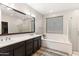 Luxurious bathroom featuring double sinks, a soaking tub, and a glass-enclosed shower at 22538 E Tierra Grande --, Queen Creek, AZ 85142