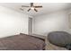 Neutral bedroom featuring ceiling fan, carpeted floor, and minimal decor for a calm and restful ambiance at 22538 E Tierra Grande --, Queen Creek, AZ 85142
