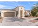 Inviting single-story home featuring arched porch, two-car garage, and low-maintenance desert landscaping at 22538 E Tierra Grande --, Queen Creek, AZ 85142