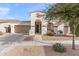 Lovely single-story home with an arched porch, two-car garage, and a well-maintained desert landscape at 22538 E Tierra Grande --, Queen Creek, AZ 85142