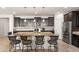 Large kitchen island offering bar seating, surrounded by dark cabinetry and stainless steel appliances at 22538 E Tierra Grande --, Queen Creek, AZ 85142