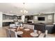 Open concept kitchen, dining, and living area with dark wood accents at 22538 E Tierra Grande --, Queen Creek, AZ 85142