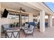 A covered patio featuring comfortable seating, a ceiling fan, and sliding glass doors at 22538 E Tierra Grande --, Queen Creek, AZ 85142