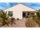 View of the back of the house, showing the covered patio, and desert landscaping at 22565 W La Pasada Blvd, Buckeye, AZ 85326