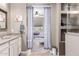 Bathroom with a tiled floor and showing a large bathtub and bedroom beyond at 22565 W La Pasada Blvd, Buckeye, AZ 85326