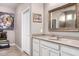 Bright bathroom with a granite counter and a large mirror to let in light at 22565 W La Pasada Blvd, Buckeye, AZ 85326