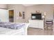 Bedroom featuring a large flatscreen television, dresser, and unique artwork at 22565 W La Pasada Blvd, Buckeye, AZ 85326