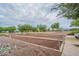 Outdoor bocce ball court surrounded by desert landscaping and views of nearby golf course at 22565 W La Pasada Blvd, Buckeye, AZ 85326