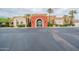 A community clubhouse welcomes visitors with its landscaped entrance and convenient parking at 22565 W La Pasada Blvd, Buckeye, AZ 85326