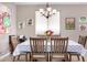 Cozy dining room featuring a wooden table, seating for six, and decorative chandelier at 22565 W La Pasada Blvd, Buckeye, AZ 85326