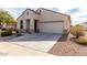 Charming single-story home with a two-car garage and low-maintenance desert landscaping at 22565 W La Pasada Blvd, Buckeye, AZ 85326