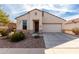 Charming single-story home with a two-car garage and low-maintenance desert landscaping at 22565 W La Pasada Blvd, Buckeye, AZ 85326
