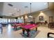 Game room featuring billiard tables and comfortable seating, perfect for recreation and socializing at 22565 W La Pasada Blvd, Buckeye, AZ 85326