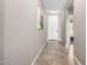 Inviting hallway featuring neutral wall color and tile flooring, leading to various rooms at 22565 W La Pasada Blvd, Buckeye, AZ 85326