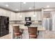 Well-appointed kitchen with granite countertops, updated appliances, and an island with seating at 22565 W La Pasada Blvd, Buckeye, AZ 85326