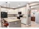 Open kitchen featuring a large island with seating, granite countertops, and ample cabinet space at 22565 W La Pasada Blvd, Buckeye, AZ 85326