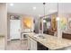 Functional kitchen island with granite countertops, double sink, and modern appliances at 22565 W La Pasada Blvd, Buckeye, AZ 85326