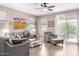Cozy living room with a ceiling fan, tile floors, and sliding doors to the backyard at 22565 W La Pasada Blvd, Buckeye, AZ 85326