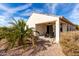 Covered patio with ceiling fan and outdoor seating offers a relaxing outdoor living space at 22565 W La Pasada Blvd, Buckeye, AZ 85326