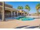 A sparkling pool with sun loungers, palm trees, and a resort-style swimming experience at 22565 W La Pasada Blvd, Buckeye, AZ 85326