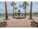 A tiered fountain highlights the beautiful resort-style pool and surrounding palm trees at 22565 W La Pasada Blvd, Buckeye, AZ 85326