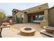 Beautiful backyard with built in BBQ, fire pit, travertine pavers, and outdoor seating at 2320 E Allen St, Phoenix, AZ 85042